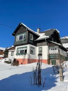 a large house with snow on the ground at Ferienwohnung Sonnschein in Bad Mitterndorf