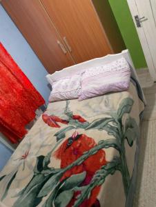 a bed with a comforter with a bird on it at Sacred Heart Apartments BNB & Hostels Meru Town in Meru +1 photo