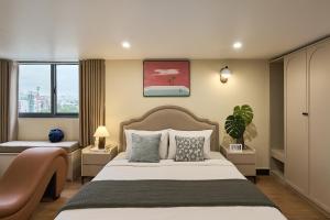 Ένα ή περισσότερα κρεβάτια σε δωμάτιο στο Secret Garden Hotel Phan Xich Long