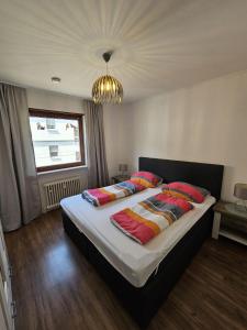a bedroom with a large bed with pillows on it at Central-Apartment-Adria in Saarbrücken