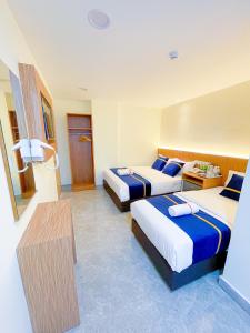 Ένα ή περισσότερα κρεβάτια σε δωμάτιο στο Astar Hotel