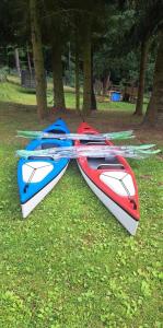 two kayaks sitting on the grass in a park at Dom na Mazurach Zatoka Leśna in Wieniec +2 photos