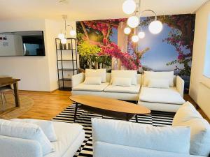 a living room with white couches and a table at Hotel Nova Limbach in Limbach - Oberfrohna