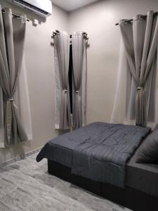 a bedroom with curtains and a bed in a room at Teratak Nu'aiman With Pool in Bedung +8 photos