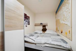 a small bedroom with a bed with a teddy bear on it at Ferienhaus 35 in Stelzendorf
