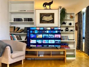 a large screen television in a living room at Villa Nisula - yläkerran asunto in Teuva