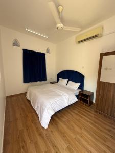 Postel nebo postele na pokoji v ubytování Tilal Al-Qattara