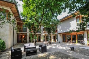 an outdoor patio with furniture and a building at Hôtel Les Esclargies in Rocamadour