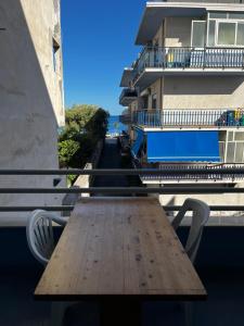 a wooden table on the balcony of a building at Casa marina in Furci Siculo +1 photo