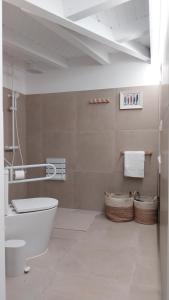 a bathroom with a tub and a toilet and towels at La Mar de Nueva AT in Nueva de Llanes