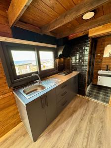 a kitchen with a sink and a counter top at Goga Otel in Sarıyer