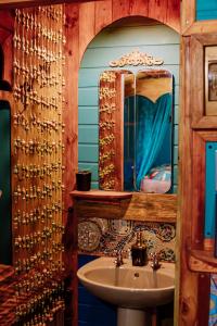 a bathroom with a sink and a mirror at Gypsy Vans Weskus in Jacobs Bay