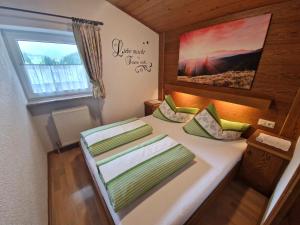 a small bedroom with a bed in a tiny house at Haus Daheim in Sankt Leonhard im Pitztal