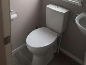 a bathroom with a white toilet and a sink at 30 Wells Close in Cheswick