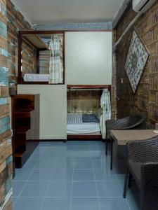 a bedroom with a bed and a table and chairs at Bụi Homestay - Ferry to Rạch Giá in Rạch Giá