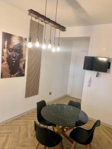 a dining room with a glass table and chairs at Casa Amore Design - South Sardinia - in San Gavino Monreale