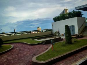 a house with a brick walkway next to a building at Cebu CozyStay in Mandaue City