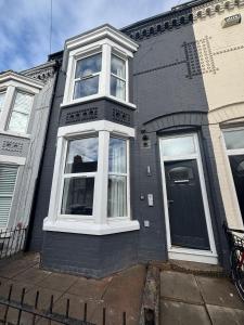 a black house with white windows and a door at Bedford Guesthouse in Liverpool