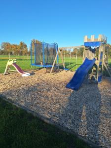 a playground with several different types of playground equipment at Au Cœur Des Champs in La Petite-Boissière