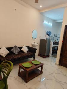 a living room with a couch and a table at Buddha Home stay in Mahabalipuram