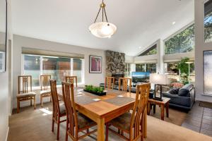 a dining room and living room with a table and chairs at Spacious Riverfront home in Nebelhorn
