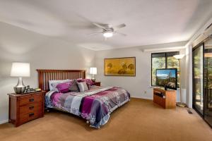 a bedroom with a bed and a ceiling fan at Spacious Riverfront home in Nebelhorn