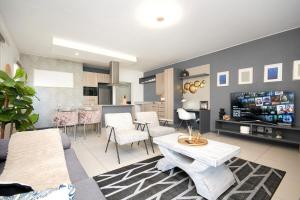 a living room with a couch and a table at The Atrium, Sandton Apartment in Johannesburg