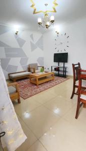 a living room with a couch and a table at Mike's HOUSE in Yaoundé