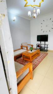 a living room with a couch and a tv at Mike's HOUSE in Yaoundé