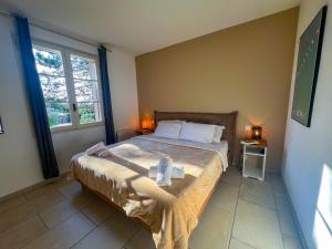 een slaapkamer met een bed met handdoeken erop bij Charming house in Oppede - Swimming Pool & Tranquility in Oppède +54 foto's