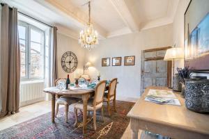 a dining room with a table and chairs and a chandelier at Luxurious Provencal Village House, Walk to Village Pool in Rustrel