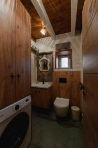 a bathroom with a toilet and a sink at Scandinavian Rustic in Tríkala