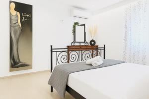 a bedroom with a bed with a mirror on it at Belvedere Luxury Suite in Tríkala