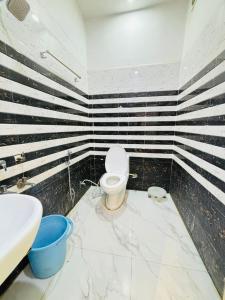 a bathroom with a toilet and a sink at Vaidik Harmony Ayodhya in Ayodhya +42 photos