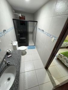 a bathroom with a sink and a toilet at Pousada Dra Lindalva in Maragogi