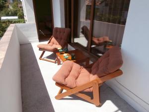 two chairs sitting on top of a balcony at Apartments in House Silent Nature in Sandanski