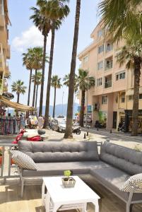 a couch and chairs on a street with palm trees at The Marmaris Boutique Hotel in Marmaris