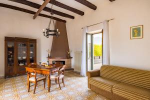 a living room with a table and a couch at Tenuta Nunziata - food, event, biofarm in Torre Annunziata