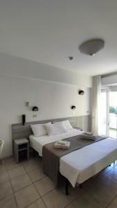 a large bedroom with two beds and a window at Hotel Eva in Rimini