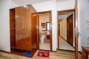 a bathroom with a toilet and a mirror at Hotel Anh Đức 2 in Ga Phú Văn +121 photos