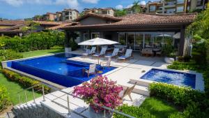 an aerial view of a house with a swimming pool at Casa Ohana 5 bdrs ocean view in Los Suenos in La Mona