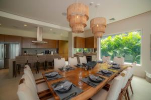 a dining room and kitchen with a table and chairs at Casa Ohana 5 bdrs ocean view in Los Suenos in La Mona