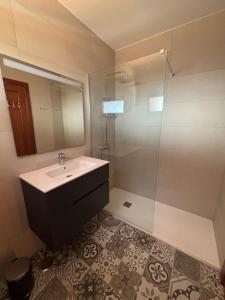 a bathroom with a sink and a shower at Casa Mía in Corralejo +13 photos