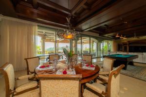 a dining room with a table and ping pong ball at Casa Garmus 10 bdrs ocean views in Los Suenos in Herradura
