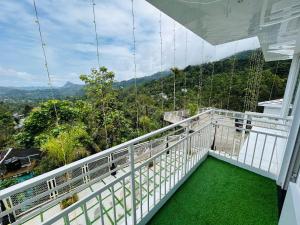 a balcony with a view of the mountains at Munnar Peak Paradise in Anachal