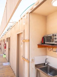 a kitchen with a sink and a toaster oven at כפר הצוללים in Eilat
