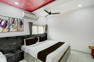 a bedroom with a bed and a ceiling fan at Collection O Karmanghat Bus Terminal Hyderabad Formerly Hotel Chirag Stays in Hyderabad