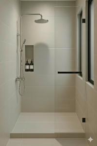 a shower with a glass door in a bathroom at Centraltique Veranda Living in Hanoi +35 photos