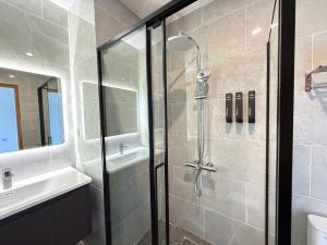 a bathroom with a shower and a sink at Amarin Resort & Spa Phu Quoc in Phú Quốc