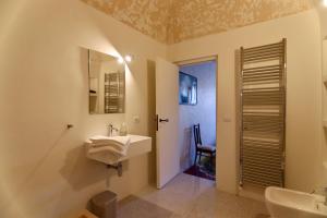 a bathroom with a sink and a mirror at Palazzo Palloni: Piano Nobile in Sorano +30 photos